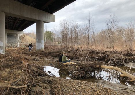 people sitting underneath overpass, drawing.